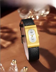Macro view of gold rectangular alloy case with brushed finish and black leather strap