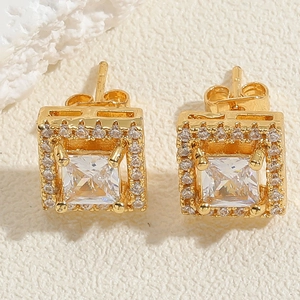 Macro detail of square gold-plated stud earrings with pavé cubic zirconia halo