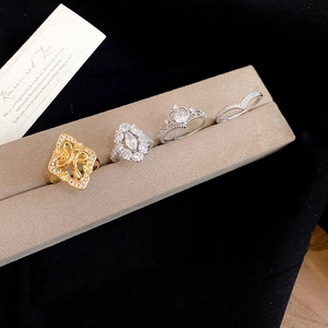 Close-up of four-piece luxury gold ring set with marquise zircon flower and crown designs