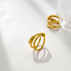 Detail of twisted multi-layer knot ring in 18K gold plated titanium steel finish