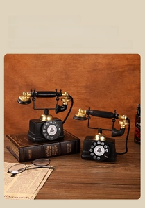Macro view of vintage style telephone model ornament with black and gold details
