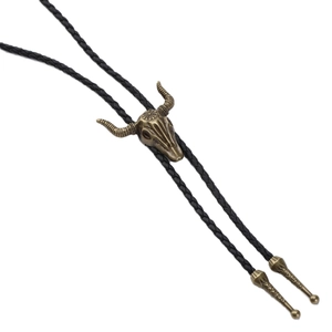 Vintage western bolo tie with bronze bull skull metal slider and black braided cord strap