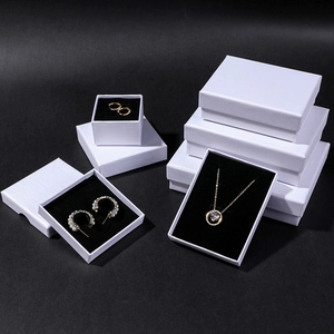Elegant white textured jewelry boxes with black velvet lining in various sizes