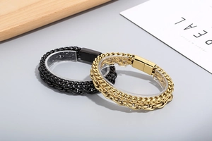 Close-up of double-layer stainless steel bracelets in black and gold with magnetic clasp