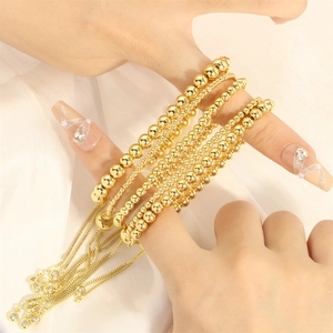 Detail of adjustable 18K gold plated beaded bracelets with zircon charms on silk