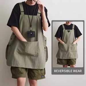 Olive green reversible canvas work apron with large front pockets and side buttons