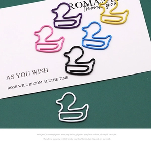 Macro shot of colorful duck-shaped paper clips in six vibrant colors for creative office use