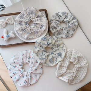 5-piece set of floral cotton scrunchies in blue, yellow, and cherry prints for women