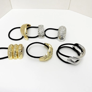 Detail of 6 elastic hair ties with diverse gold and silver metallic bow-knot ornaments