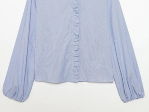 Detail of blue and white striped poplin shirt with ruffled front and lantern sleeves