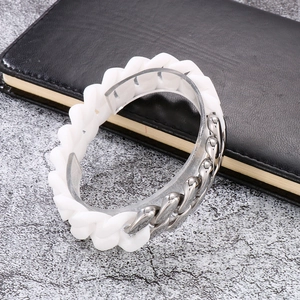 Detailed shot of two-tone Cuban link bracelet with white silicone and silver steel links