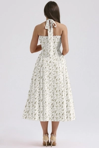 Detail of floral halter dress featuring a back tie-up bow and green floral print