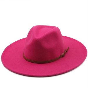 Detail of fuchsia wool fedora hat featuring a brown leather strap and metal buckle