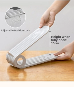 Detail of adjustable buckles on the white shoe rack showing full 15cm height expansion