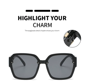 Detail view of square black sunglasses showing durable metal hinge and glossy finish