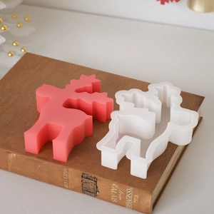 3D reindeer silicone mold for DIY Christmas candles and resin crafts on vintage book