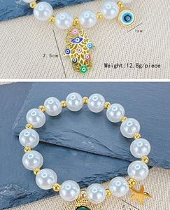 Detail view of Hamsa Hand and Evil Eye charms on beaded bracelet with 12.8g weight label