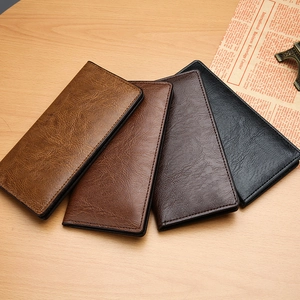 Men's business long leather wallets in four classic colors on a wooden surface