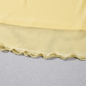 Detail of the yellow mesh top featuring a delicate lettuce edge hem and sheer fabric texture