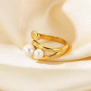 Minimalist irregular double band gold ring with two white pearls on satin background