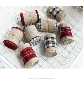 Detail of Christmas jute ribbons with red and black checkered edges in a white basket