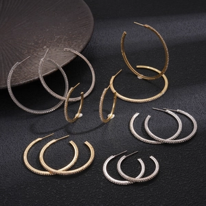 Minimalist geometric hoop earrings with pavé crystals in gold and silver finishes