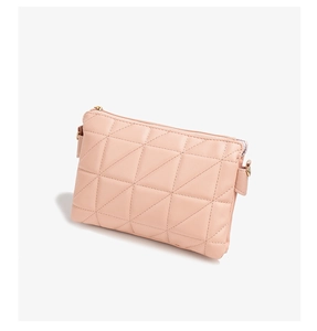 Detail of pink PU leather crossbody bag with geometric quilted stitching and gold hardware