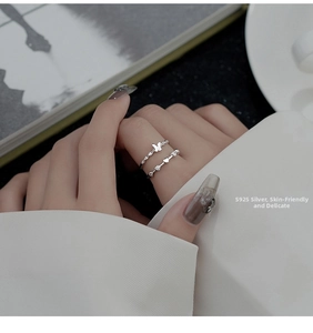 Close-up of S925 sterling silver woven butterfly and heart ring set with tiny zircon stones