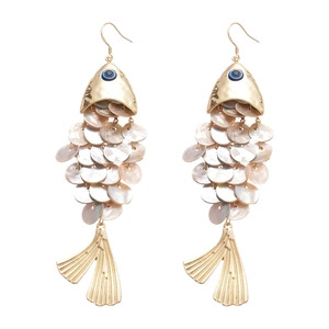 Vintage gold fish-shaped earrings with shell scales and blue gemstone eyes on white background