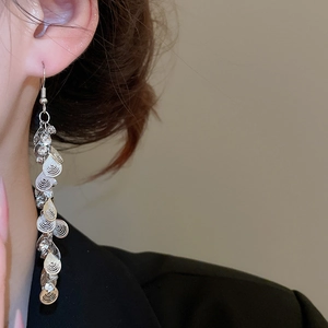 Detail of silver drop fringe earrings with sparkling crystals and metal sequins