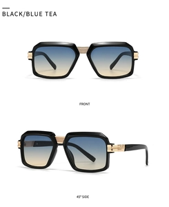 Detail of square sunglasses showing golden metal hinges and blue-brown gradient lenses