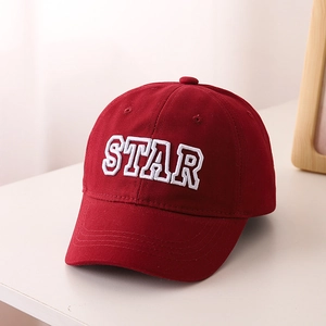 Detailed view of kids' red cotton baseball cap with white 3D star embroidery texture