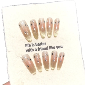 Golden cat eye gradient press-on nails set with almond shape and star rhinestones