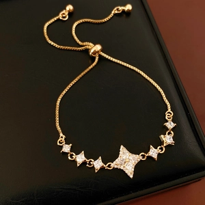 Detailed shot of golden star bracelet with pavé zircons and adjustable slider clasp