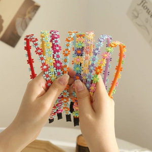 Colorful daisy floral headbands for women featuring vibrant fabric flower patterns