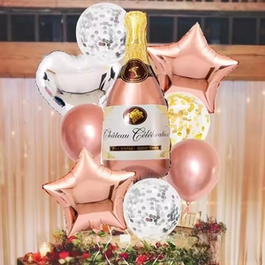 Close-up of champagne bottle and rose gold star foil balloons for party venue decoration