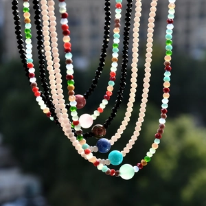 Detailed macro view of colorful agate and crystal beaded necklace with outdoor background