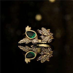 Gold plated leaf and hummingbird open ring with green crystal and micro-pave crystals