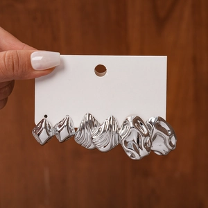 Detail view of 3 pairs set silver textured earrings with liquid metal rippled surface