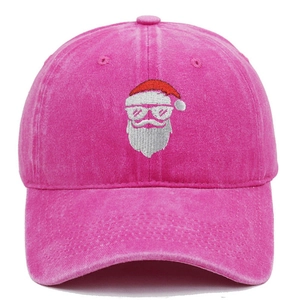 Close-up of Santa Claus embroidery on a vintage washed pink cotton baseball cap