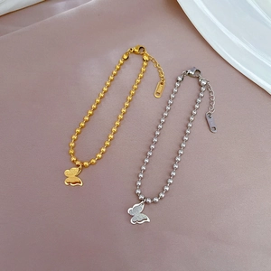 Polished titanium steel beaded bracelet with double-layer butterfly pendants in gold and silver