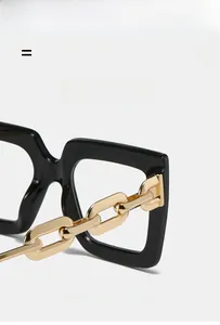 Detail of trendy thick gold chain temples on stylish black oversized square glasses frames