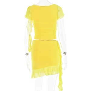 Close-up of yellow two-piece set featuring pleated mesh fabric and ruffle hem details
