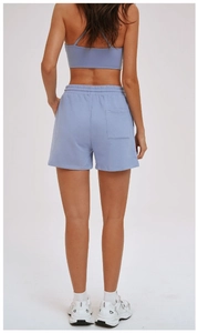 Rear view of light blue athletic shorts with back pocket and matching sports bra top