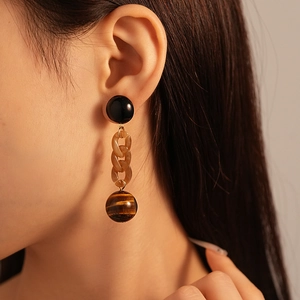 Maillard style resin chain earrings with faux tiger eye stone beads on a female model