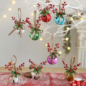 Christmas wind chime bells with red berries and bows on white branches for holiday decor