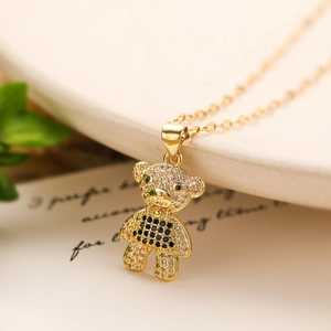 Charming gold-plated bear pendant necklace with sparkling black and clear cubic zirconia