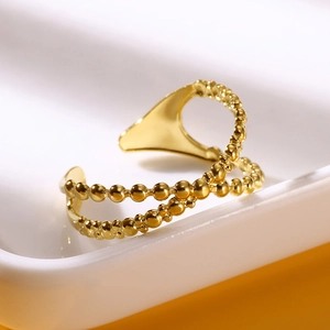 Detail view of double-layer gold plated beaded stainless steel ring on a white display tray