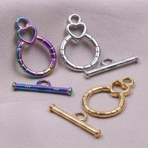 Macro shot of stainless steel heart OT toggles in gold, silver, and rainbow finishes