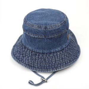 Detail of dark blue denim bucket hat showing stitching and adjustable windproof drawstring